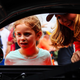 Aurora Straus shows a young girl her race car. Photo credit: Wes Duenkel, used with permission
